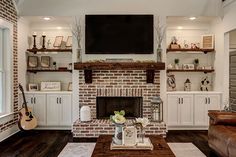 a living room filled with furniture and a flat screen tv mounted above a fire place