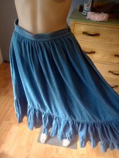 This is a very cute 1980s Western denim ruffled full skirt. The skirt is very cute and in great condition! The skirt has 2 pockets and a button to close at the waist.  This is perfect for a line dance, a western dance a day at work or just a fun day! You could wear it with a blouse or sweater or T-shirt.  The brand is The Private Line and it was made in Hong Kong.  The size says 7/8. Exact measurements are across the front of the skirt.  Waist 12.5" Hips free and full Length 28.5" Message me with any questions. No returns. Free shipping in the USA. Skirt Ruffles, Western Dance, Rock Hat, Coos Bay, Line Dance, Line Dancing, Fun Day, Jeans Rock, Womens Skirts