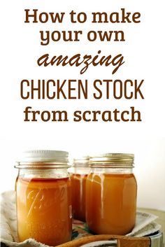 two jars filled with chicken stock sitting on top of a table