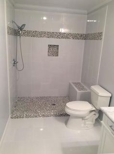 a bathroom with a toilet, sink and shower