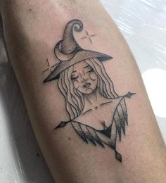 a woman's leg with a witch hat on it