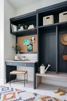 a room with a desk, chair and bookshelf filled with various items on it