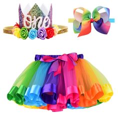 two pieces of clothing with bows and ribbons on hangers, one is multicolored