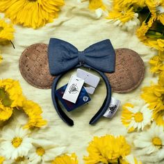 a mickey mouse ears headband with blue bow tie and other items laid out next to it