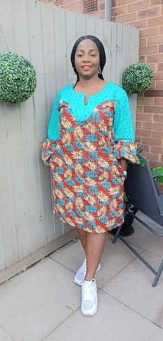 Ankara midi shift dress with beautifully intricate lace detailing is gorgeous and on trend with fitted to puff sleeve. Perfect for informal events, get to together when you simply need to make an effortless statement!  Unlined Colour: multi - colour Fit: loosely shaped Sleeve: fitted regular Pocket: two side pockets Length: knee African print  CARE INSTRUCTIONS: Hand wash cold. DO NOT BLEACH. Hang dry. Press with cool iron on the wrong side only. Colour may vary slightly due to lighting. Long Sleeve Lace Dress With Patchwork, Summer Knee-length Dress With Lace Sleeves, Elegant Patchwork Shift Dress, Elegant Shift Dress With Patchwork, Knee-length Summer Midi Dress With Lace Sleeves, Knee-length Midi Dress With Lace Sleeves For Summer, Casual Green Dress With Lace Patchwork, Summer Knee-length Midi Dress With Lace Sleeves, Fitted Lace Dresses With Patchwork Details