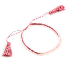 a pink bracelet with tassels and beads