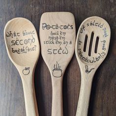 three wooden spoons with writing on them