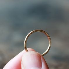 Entirely hand-forged and handmade from solid 14k gold, this is a lovely and simple ring perfect for everyday wear. At 1.6mm wide and 1.5mm thick, it is more substantial than my slim hammered bands. I can make this ring in either 14k yellow or 14k rose gold (the photos show yellow gold). The top is lightly hammered to create shimmering details, while the sides and interior remain smooth. This ring has a timeless elegance that will last for generations, perfect for a woman's wedding band. This is Minimalist Hand Forged Engraved Promise Ring, Hand Forged 14k Gold Stackable Rings With Round Band, Hand Forged 14k Gold Engraved Wedding Ring, Hand Forged Stackable 14k Gold Rings With Round Band, Hand Forged 14k Gold Engraved Promise Ring, Minimalist Hammered Yellow Gold Rings, Hand Forged Dainty Rings In Recycled Gold, Dainty Hand-forged Rings In Recycled Gold, Hand Forged Recycled Gold Dainty Rings