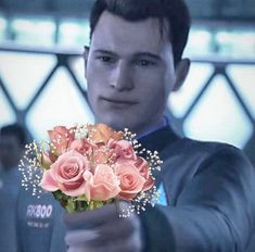 a man holding a bunch of flowers in his hand