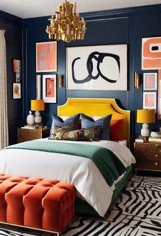 a bedroom with blue walls and orange accents