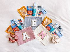 several diapers and wipes laid out in the shape of letters on a bed