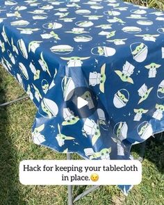 an image of a table cloth that is on top of a metal stand in the grass