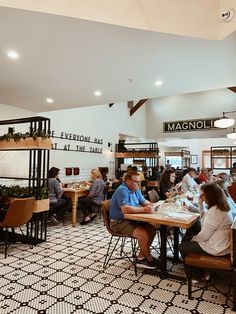 people are sitting at tables in a restaurant