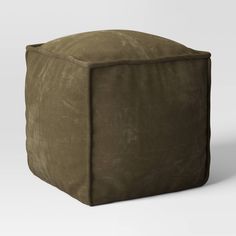 a large square shaped ottoman in brown suede fabric, on a plain white background