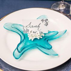 a plate with a starfish on it and a place card attached to the side