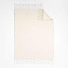 a white blanket with fringes on it