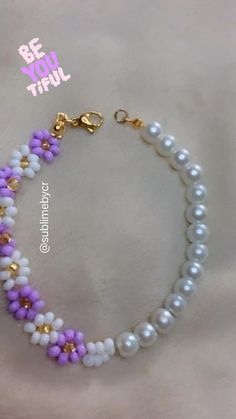 the beaded bracelet is decorated with white, purple and gold beads