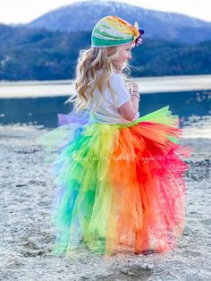 This high low tutu is next level. The front is an Ombre green and topped with a shiny gold bow. The back is over 100 yards of tulle with tiered layers creating a wild rainbow look. The back layers have glitter tulle mixed in. Sizing Info: 1-3T is roughly 6" long in the front, 20" long in the back 4-5T is roughly 8 inches long in the front, 25" long in the back 6-8 years is roughly 10 long in the front, 30" long in the back Spring Rainbow Tutu Dress With Ruffles, Tiered Tulle Tutu Dress For Dress-up, Playful Rainbow Tutu Dress For Dress-up, Rainbow Playful Tutu Dress For Dress-up, Multicolor Tulle Skirt Tutu Dress For Dress-up, Playful Multicolor Tulle Tutu Dress, Multicolor Playful Tulle Tutu Dress, Multicolor Tulle Tutu Dress For Costume Party, Multicolor Tulle Tutu Dress For Dress-up Occasions