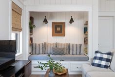 a living room filled with furniture and a flat screen tv sitting on top of a wooden table