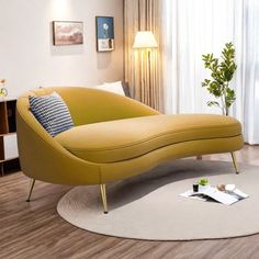 a yellow chaise lounger in a living room next to a window with curtains