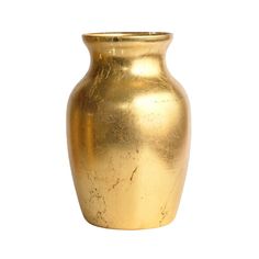 a gold vase sitting on top of a white surface