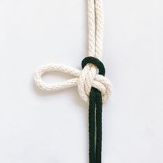 a white and black rope with a knot on it