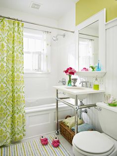 a bathroom with yellow and white decor in it