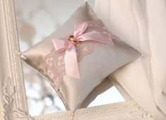 a decorative pillow with a pink bow on it