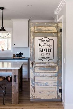 an old door is open to the kitchen and has a sign that says gourmet pantry on it