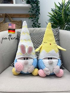 two crocheted stuffed animals sitting on top of a couch