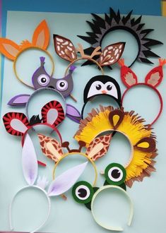 several different animal masks are arranged on a sheet of paper with scissors in the middle