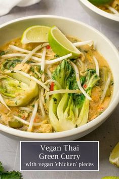 a white bowl filled with green curry and vegetables