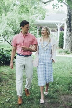 a man and woman walking in the grass