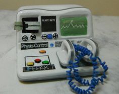 an electronic device with blue cords attached to it's side and buttons on the front