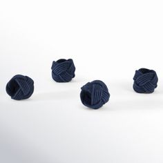 three balls of yarn sitting next to each other on a white surface with one ball in the middle