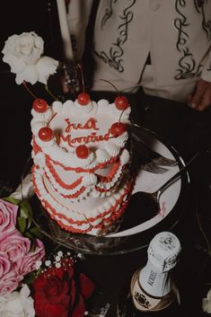 a man standing next to a cake on top of a table