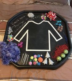 a tray that has some items on it and is decorated like a football shirt with pom poms