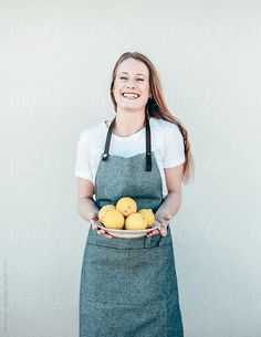 a woman holding a plate with lemons in her hands by jodi lenski for stocks on artfire