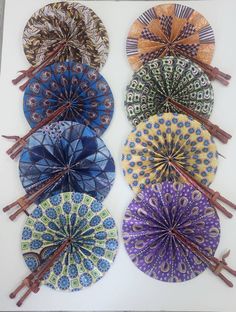 four different colored paper parasols on sticks