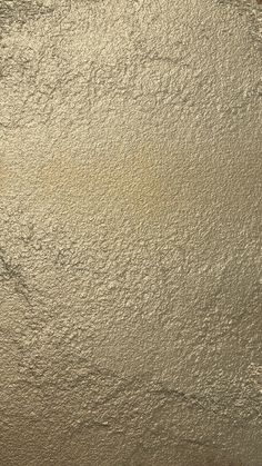 an image of a wall that looks like it has been painted gold and silver with white paint