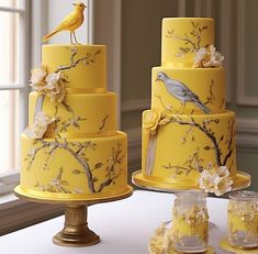 three tiered yellow cake decorated with birds and flowers