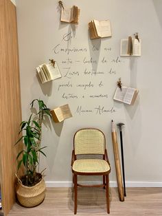 a chair sitting in front of a wall with writing on it and a potted plant