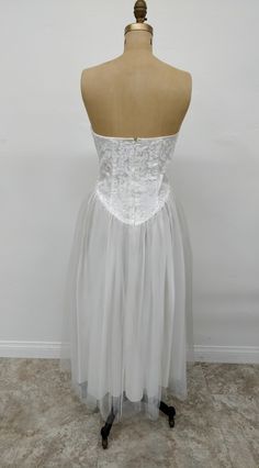 This is a lovely strapless 1950's Wedding Dress that is in an Ivory color. The bodice is lace with sequins and boning to keep its shape. The bottom is tulle over silk. There isn't a maker's tag inside which leads us to believe it is custom made. Perfect if you are looking for a shorter wedding dress. Reminiscent of the iconic Marilyn Monroe in the strapless white tutu dress. Color: Ivory Size: Waist can fit 24-26 and bust is 34-36. It is 40" L ATTENTION: This item is vintage and is sold "as is". Shorter Wedding Dress, 1950's Wedding Dress, Iconic Marilyn Monroe, White Tutu Dress, 1950s Wedding Dress, Ballet Recital, 1950s Wedding, White Tutu, Short Wedding Dress