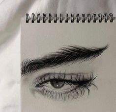 a pencil drawing of an eye with long lashes and eyelashes on it's side