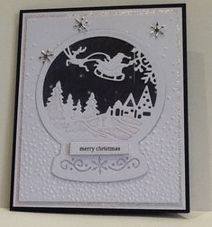 a christmas card with a snow globe and santa's sleigh on it