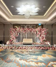 an elegant wedding ceremony setup with flowers on the stage