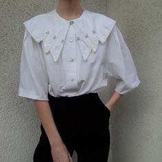 Vintage viscose-blend white blouse - unique voluminous collar Made in Finland Maschine washable closes with buttons Label size : 38 - best fits S-M-L,  please check the measurements below The model is 180 cm /5.9 tall, usually wears XS or S size MEASUREMENTS (laid down, seam to seam) Shoulders - 43 cm / 16.9 inches Armpits - 60 cm / 23.62 inches Length - 67 cm / 26.37 inches Sleeves - 33 cm / 12.99 inches COMPOSITION 67% viscose 33% polyester CONDITION good vintage *PLEASE NOTE. Due to monitor d Classic Workwear Tops With Embellished Collar, Classic Embellished Collar Tops For Workwear, Classic Tops With Embellished Collar For Workwear, Spring Formal Blouse With Embellished Collar, Elegant Workwear Blouse With Detachable Collar, Elegant Tops With Detachable Collar For Workwear, Elegant White Tops With Detachable Collar, Elegant White Top With Detachable Collar, Elegant Blouse With Detachable Collar For Work