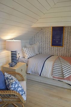 a bed room with a neatly made bed and pillows