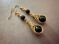 Mixed metal lightweight earrings with jet black onyx gemstones. Gold tone aluminum wire wrapping and gold finished stainless steel earring wires.   Earring wires and wire wrapping are all hypoallergenic. Drop is 2 inches. I also have a similar style earring with a longer more dramatic 2 1/2 inch drop: https://www.etsy.com/listing/1619536862/onyx-mixed-metal-earrings-hypoallergenic?click_key=b1e4e772c577a73ae286e36212eca2b3308820f1%3A1619536862&click_sum=50df4060&ref=shop_home_active_1&sca=1&sts= Black Wire Wrapped Drop Earrings, Black Wire Wrapped Metal Earrings, Earrings Hypoallergenic, Mixed Metal Earrings, Wrapped Earrings, Earring Wires, Wire Wrapped Earrings, Lightweight Earrings, Metal Earrings