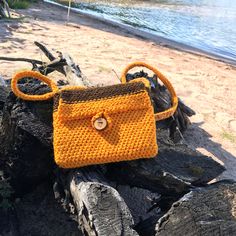 "We would like to introduce you our new limited edition collection of Made in Montana fall color handbags / cross body bags. Each bag is one of a kind and quite special. There is no two bags alike. Each bag of this collection had been hand knitted by one of our artisans without any tools using a very old technique. This orange and brown crossbody bag is very unique. It has been hand knitted from a vintage 1970 rug yarn. The lining with pumpkin vine ornament inside the bag and on the strap is made of a cotton patchwork fabric. The natural wood button can be personalized (wood burning) with your name, a short phrase or initials (see samples of personalization in the picture gallery). Please let us know at checkout if you'd like to personalize. Our beautiful bag will be an unusual gift for yo Brown Hand-knitted Rectangular Bag, Brown Crochet Bag Gift, Brown Crochet Bag For Gift, Brown Knitted Rectangular Shoulder Bag, Handmade Brown Crochet Crossbody Bag, Crochet Brown Shoulder Bag Gift, Travel Knitted Brown Shoulder Bag, Crochet Brown Shoulder Bag For Gift, Brown Crochet Shoulder Bag Gift